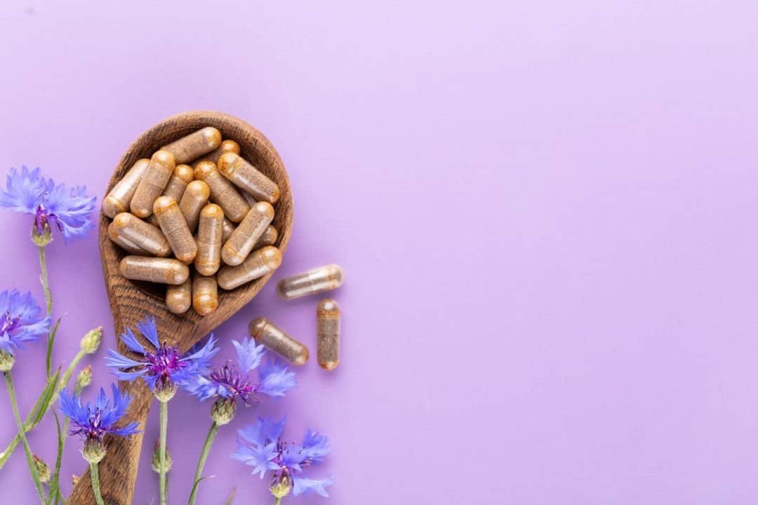 suplementos alimenticios y flores con fondo morado